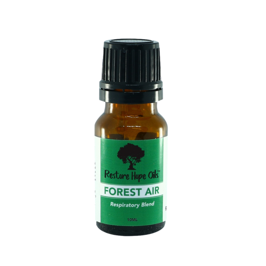 A small dark glass bottle with a black cap labeled 'Forest Air Respiratory Blend' from Restore Hope Oils.